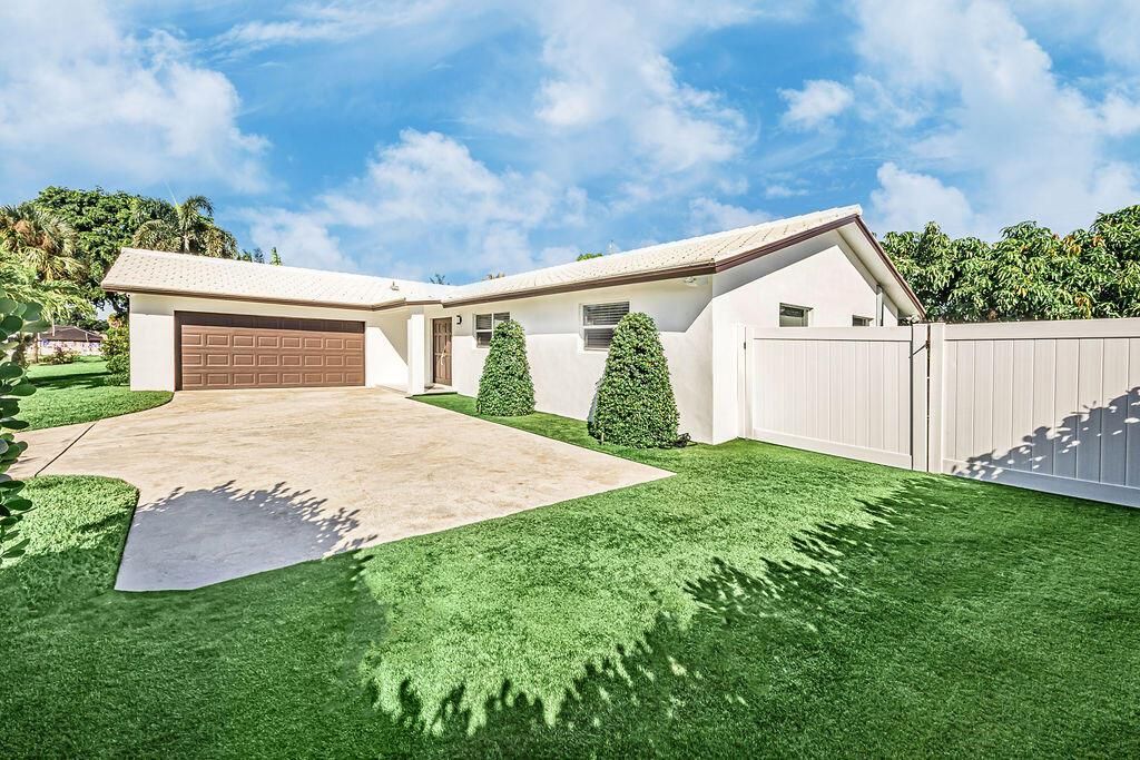 Photo of 1881 Caribbean Road W, Lake Clarke Shores, FL 33406 (MLS # R11133516)