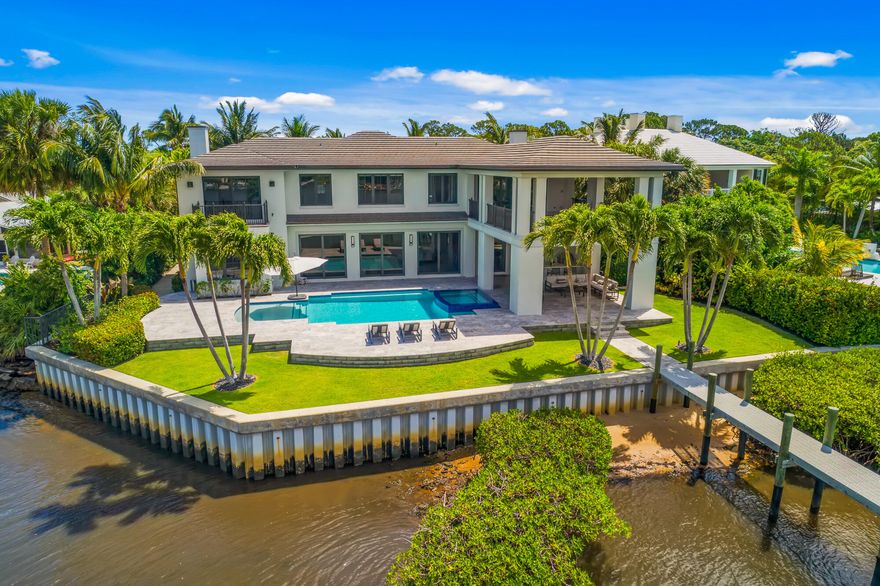 With unparalleled detail and craftsmanship, this 2016 impeccably built home by Turtle Beach Construction sits on three-quarters of an acre with 128 ft of panoramic views of the Loxahatchee River.   This spectacular home features 8,302 square feet, gorgeous wood and stone floors throughout, impact glass and doors, 5 spacious bedrooms, 7.5 baths, spectacular river views from almost every room and rare four car garage.  The spacious and luxurious master suite has two huge closets, a stunning bathroom with oversized shower,  soaking tub and his and her vanities.  This awesome gourmet kitchen consists of an oversized island, top of the line stainless-steel appliances and modern style cabinets, and opens to the dining area and family room, making this the best entertaining area and views anyone