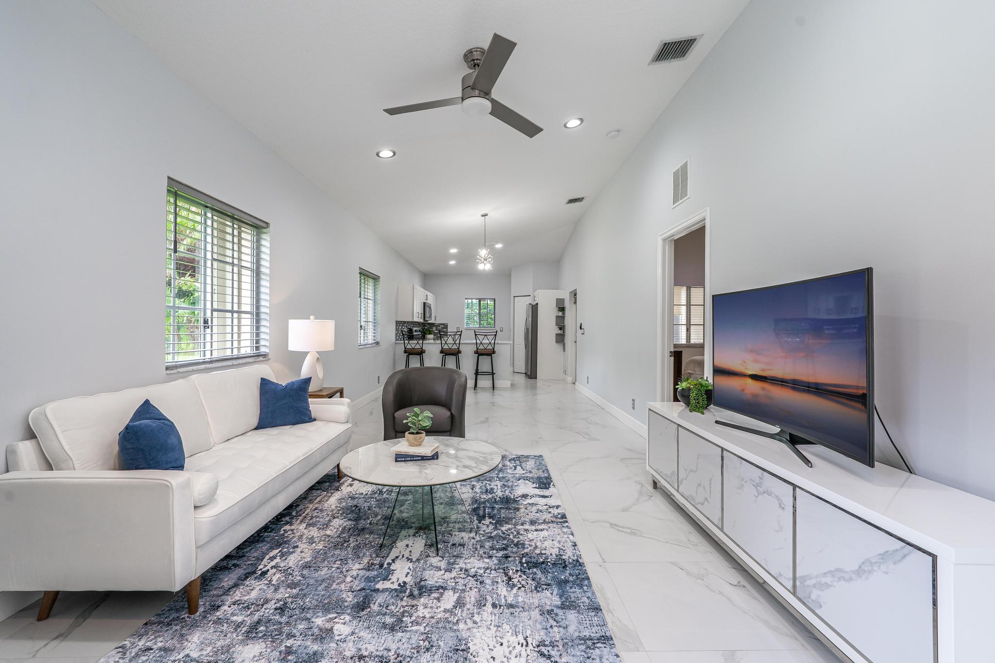 Rarely available, absolutely stunning corner unit in the pristine and luxurious 55+ community of Baywinds! Enjoy privacy and tranquility in your new home as your backyard oasis looks out over lush landscaping with no neighbors behind or to the side of you. Fully remodeled with upgrades including but not limited to, newer AC with UV light system, tile floors throughout, granite kitchen countertops and so much more. Community offers luxurious resort style living boasting multiple pools, spa, clubhouse, tennis, pickleball, game room, the list goes on. Centrally located near shops and dining and Palm Beach International Airport.
