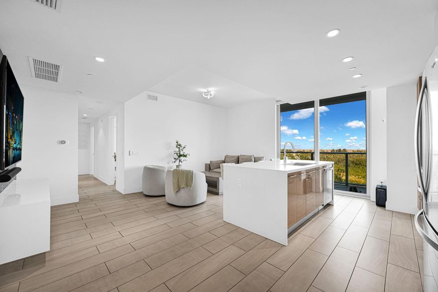 Wake up to breathtaking North facing views from your oversized private balcony in this immaculate and beautifully upgraded 3 bedroom, 3 bath unit. Designed with both style and function in mind, this spacious unit features a custom TV accent wall, thoughtfully added storage closets throughout, and built-in closets in every bedroom. The primary suite offers dual closets for added convenience, while the laundry room includes a built-in counter for everyday ease. Enjoy resort style living with a large pool, tennis courts, full-size gym, spa with sauna, theater room, playroom, BBQ area, valet and guest parking, 24-hour security, concierge service, and secured elevator access. Ideally located near Sawgrass Mills and endless dining options.