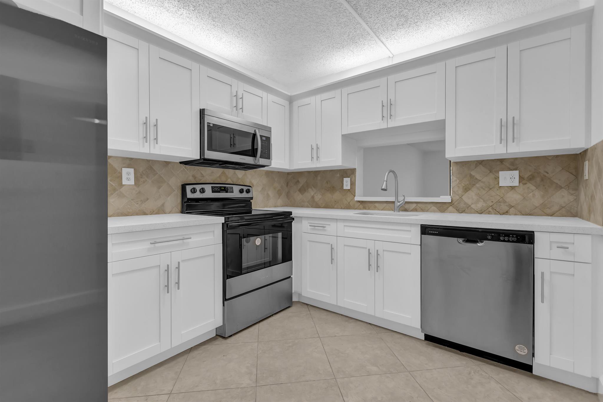 Welcome to this ground-level condo in the exclusive 55+ gated community of Somerset. This updated unit offers a spacious layout, featuring 1 large bedroom and 1.5 bathrooms, with ample closet space. Step inside, you'll notice the freshly painted and bright atmosphere, enhancing the home's modern appeal. The fully enclosed patio extends the living space, offering a versatile area for relaxation or entertainment.The kitchen is a standout featuring with white soft-close shaker cabinets, quartz countertops, and new appliances. The unit features a new AC unit in 2023. This home boasts close proximity to the community pool, mail box, and laundry, allowing for easy access to leisure and recreation.