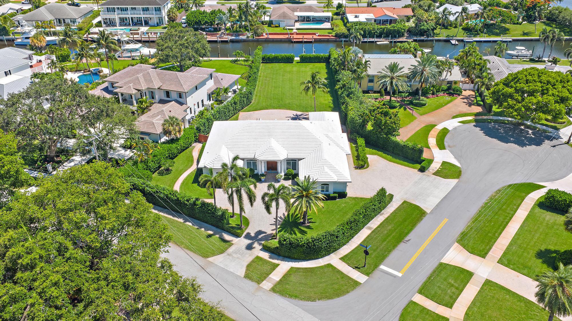 One of the finest lots in all of North Palm Beach...A HUGE yard, 75' of water frontage, 55'dock, 16k lb boat lift, NO fixed bridges - All located only minutes to North Palm Beach Country Club! Enjoy luxury living on this extremely rare .64 acre waterfront property in the Village of North Palm Beach. This impeccable property presents endless possibilities with the current residence boasting 3,630 sq ft of living space and 5,023 total sq ft, featuring 5 bedrooms, 1 or 2 offices, TV room and a spacious open-concept kitchen and great room that overlook the sparkling swimming pool and vast backyard, complete with mature, lush hedges for ultimate privacy.Move in, renovate, or design and build your own dream custom estate, this unique lot offers a canvas for creating your ideal home.  The...
