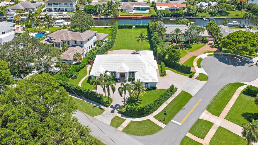 One of the finest lots in all of North Palm Beach...A HUGE yard, 75' of water frontage, 55'dock, 16k lb boat lift, NO fixed bridges - All located only minutes to North Palm Beach Country Club! Enjoy luxury living on this extremely rare .64 acre waterfront property in the Village of North Palm Beach. This impeccable property presents endless possibilities with the current residence boasting 3,630 sq ft of living space and 5,023 total sq ft, featuring 5 bedrooms, 1 or 2 offices, TV room and a spacious open-concept kitchen and great room that overlook the sparkling swimming pool and vast backyard, complete with mature, lush hedges for ultimate privacy.Move in, renovate, or design and build your own dream custom estate, this unique lot offers a canvas for creating your ideal home.  The...