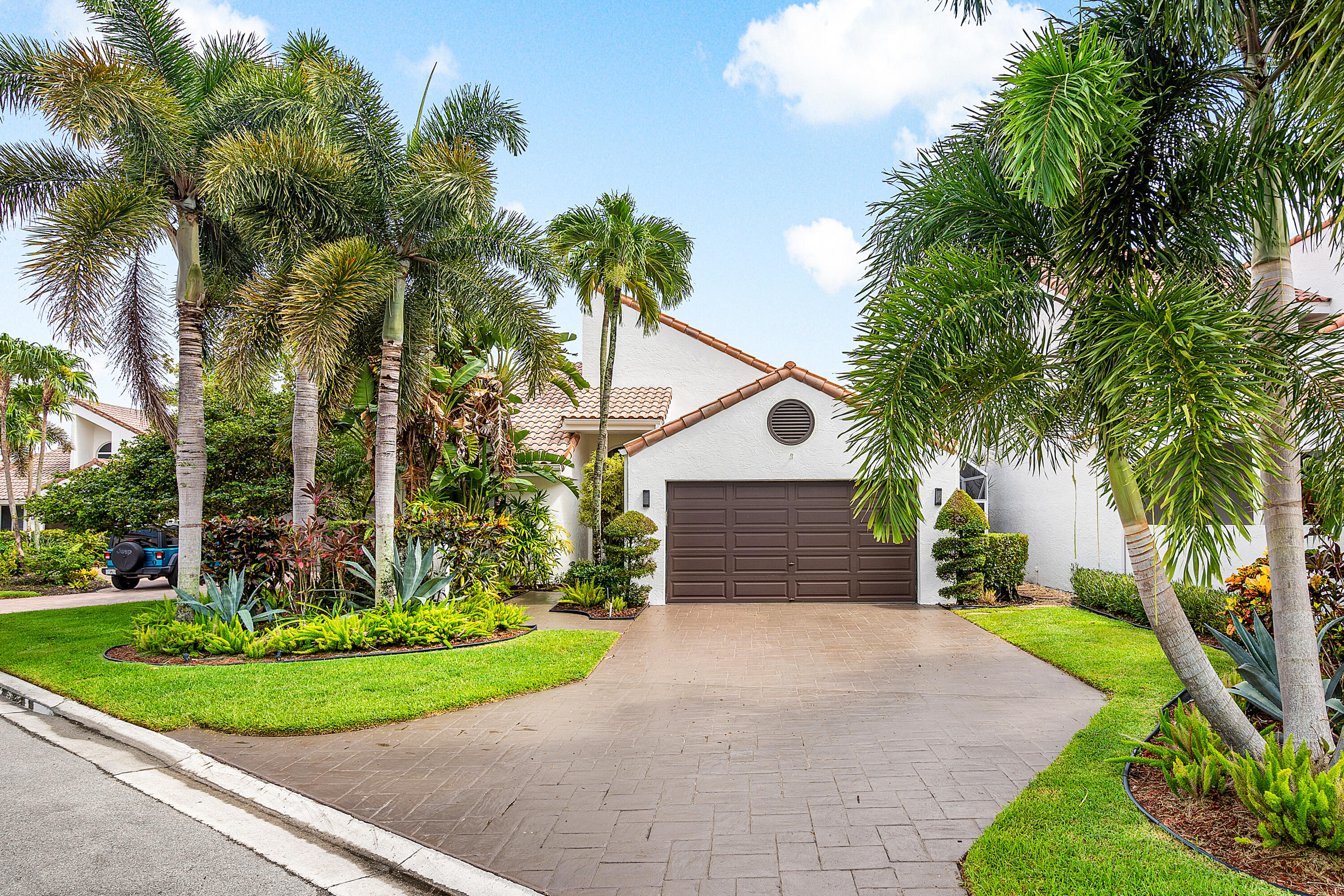 Stunning 3BR/2.5BA lakefront pool home in Newport Bay Club! This residence offers an open floor plan with complete impact windows/doors, Cristalo quartzite countertops in the kitchen, breakfast niche, and outdoor bar. Beautiful hardwood floors throughout the main areas and primary bedroom. Enjoy the redesigned screened pool area with new travertine deck, pool tiles, heater, and salt filtration system--perfect for entertaining. Additional features include 2 new AC units and flexible ducts, new water heater, Swarovski chandeliers, and a huge custom master closet. Exterior painted in 2025 with all new professional landscaping, lighting, and coach lights--this home is move-in ready and beautifully appointed inside and out. Live the country club lifestyle without the mandatory equity dues.