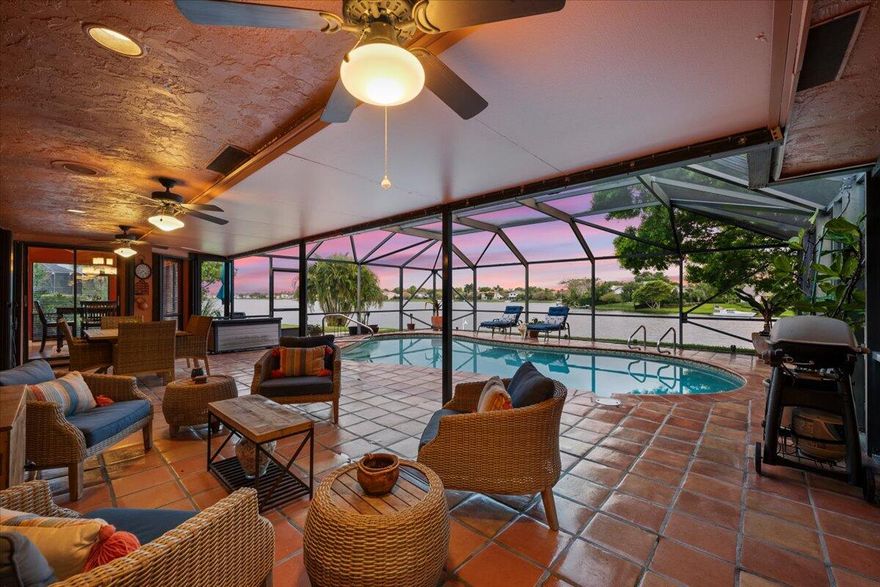 Imagine waking up to long lake views every morning, and welcoming each sunrise from your private screened pool deck, not to mention sunset boat rides on Lake Wellington.  As the cooler weather approaches, the entire back of the house can open up, affording you the luxury of building fires in BOTH wood burning fireplaces.  This well loved home even has a private office with a dedicated entrance and half bath, providing the perfect professional environment for receiving clients, separate from your living space.  The roof, floors, baseboards, lanai, and extended patio are ~eight years old.  Both AC units are 4 years old, and the electrical panel is 2025.