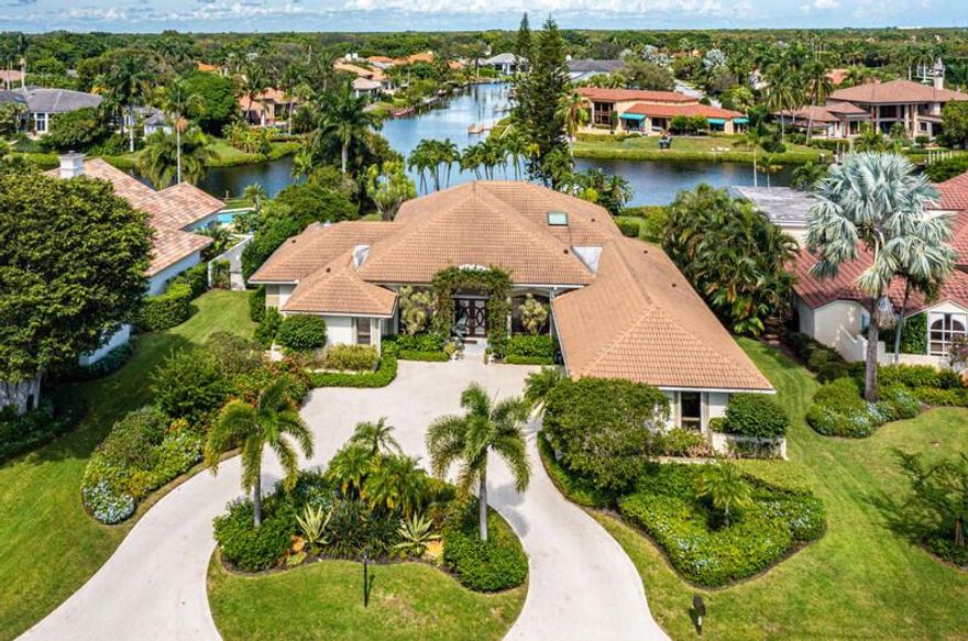 Long and panoramic interior waterway views with private dock for impressive estate offering 3BR with possible 4th BR with office conversion.  Spacious Florida room, 4 full and 1 half bath with ample living space edged in windows framing tranquil tropical views.  Travertine flooring, soaring ceilings, electric shades, oversized wetbar with wine cooler and ice maker, separate spacious dining area and 2 car newly-pattern epoxied garage with additional golf cart storage. Ideal kitchen featuring abundant wood cabinetry, Quartzite counters, double stainless steel ovens, concealed refrigerator and counter seating. Well-appointed bedrooms with primary suite offering Florida room access, oversized bath with dual vanities and dual water closets plus separate steam shower.