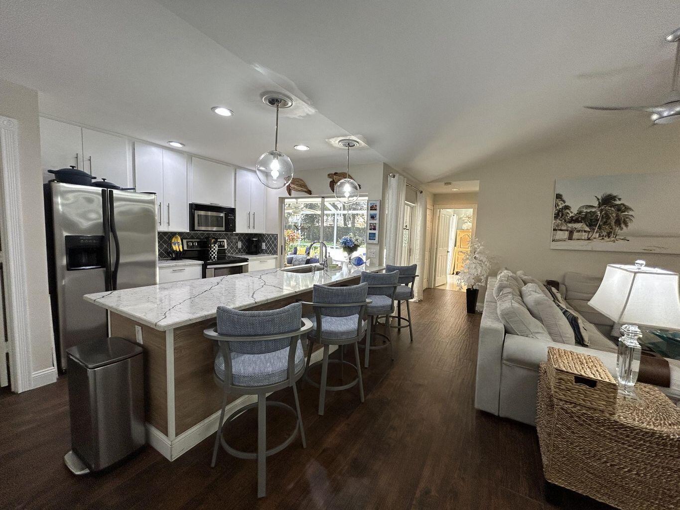 Step into this beautifully updated 2-bedroom, 2-bath villa with a spacious split floor plan and vaulted ceilings that make the Great Room feel bright and open. The large screened patio overlooks lush garden space, perfect for relaxing or entertaining guests. Enjoy a modern kitchen, comfortable living area, and built-in shelving ready to showcase your personal style.Community perks include a heated pool, lighted walking paths, and on-site management for peace of mind. Basic cable, water, and trash are included--just set up your electric, Wi-Fi, and renter's insurance.All of this just minutes from I-95, The Gardens Mall, Juno Beach, and countless dining and shopping spots.