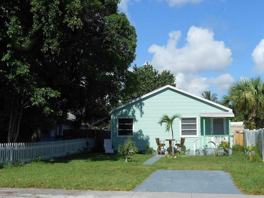 EXCELLENT CONDITION!  MOVE-IN READY!  Terrific location in Lake Worth Beach's tremendously-popular Tropical Ridge neighborhood... Desirable NORTH side of town!  You'll be pleased with all aspects of this very fine house.  The good-looking renewed interior is enjoyably spacious (uncommonly wide, bright, and airy!) with a highly-appealing design.  Timeless beauty of original hardwood floors throughout.  Large front yard + deep back yard... Oversized lot.  An all-important front driveway for parking, keeps your living standards intact.  Newly-replaced central a/c, updated electric, washer / dryer.  Enjoy walking to nearby stores, cafes, and taverns.  Less than a five minute drive to the beach.  So proud and happy you'll be, living in this well-built home... Without an H.O.A. fee!