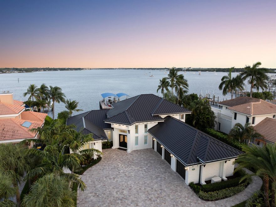 Located in the private, gated enclave of Bay Pointe, this reimagined waterfront estate offers 100' of wide river views, eastern exposure, and deep water dockage for a 95' yacht. Features include a new standing seam metal roof, PGT impact glass, marble and refinished wood flooring, and re-stuccoed exterior. The chef's kitchen has quartzite counters, custom cabinetry, Bertazzoni/Bosch appliances, Sub-Zero fridge, copper fixtures, and swing-out barstools. The primary suite offers dual walk-ins, spa bath with freestanding tub, walk-in shower, and private den with water views. Outside, enjoy a saltwater pool with marble pavers, in-pool stools, fountains, turf, putting green, and firepit. Dock includes synthetic decking, 24K/16K lifts, mooring whips, power/water pedestals