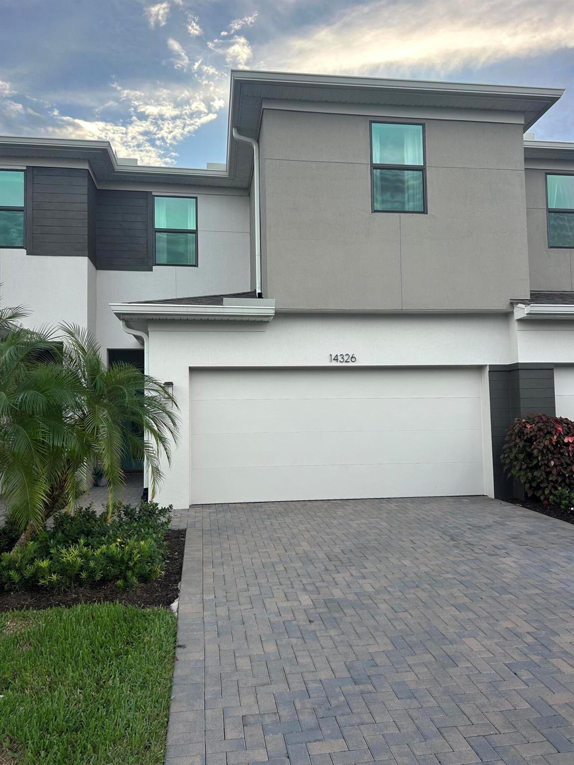 Now available in the heart of Tradition - this newly built 3 bedroom, 2.5 bath townhouse offers modern upgrades and a prime location. Enjoy the added benefit of no rear neighbors thanks to the berm behind the home, along with a 4 ft metal fence enclosing the backyard. Inside, you'll find stylish accent walls in the entry and family room, upgraded bathroom mirrors, a barn door for the pantry, and a versatile built-in Murphy bed with desk combo--perfect for guests or a home office. The garage features a durable Ox Polyaspartic floor coating, and right across the street is convenient extra parking, the community pool, mailboxes, and front office. The HOA covers lawn care, exterior insurance, cable/internet, security, and pool access, making for truly low-maintenance living.