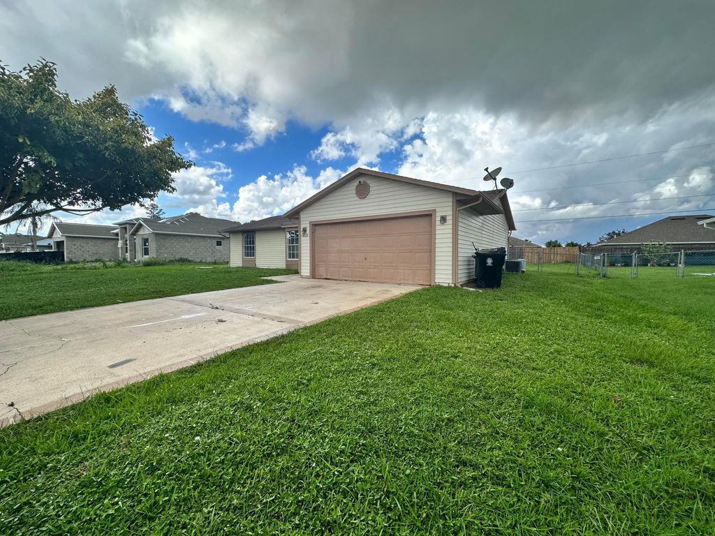 Photo of 1021 SW Dubois Avenue, Port Saint Lucie, FL 34953 (MLS # B26021413)