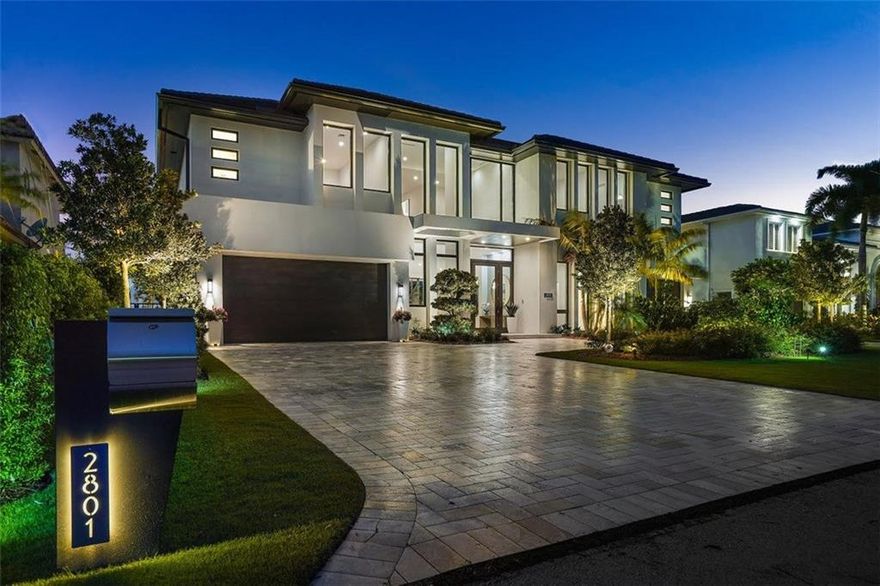 Exquisitely finished contemporary home with beautiful open water views of the South Grand Canal. The home was completed in 2022 by master builders Morgan Custom Homes, designed by architect Randall Stofft, interior design by Lighthouse Interiors and staged by Michael Gray. These professionals have put together a modern masterpiece, perfect for entertaining as well as comfortable living. This spectacularly decorated home features 5 spacious, en-suite bedrooms with walk-in closets, elevator, office with double sided fireplace and a master suite with luxurious his and hers bathrooms. Wide water views throughout the home! Featuring an open concept floor plan with expansive glass that makes the view go on and on! Relax in the palatial pool and patio area for the sought after Florida lifestyle