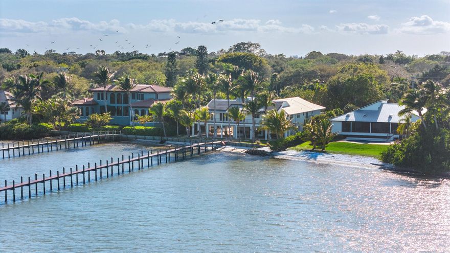 A breathtaking waterfront estate in Sewalls Point, the prestigious Sailfish Capital of the World. Nestled on a beautiful lot, this tropical retreat offers panoramic Intracoastal views, a private sandy beach, and easy kayak and paddle board access. Renovated in 2024, it boasts an updated chef's kitchen, expansive covered patios, and a lower-level build-out with a built-in grill and fridge. A whole-home photovoltaic solar system powers the property while air quality upgrades meet EPA AirPlus standards. With 5 bedrooms, 4 baths, an ADA-compliant elevator, a private dock with a boat lift, a sparkling pool & a six-car garage, this is luxury waterfront living at its finest. Minutes from Downtown Stuart and the Atlantic.