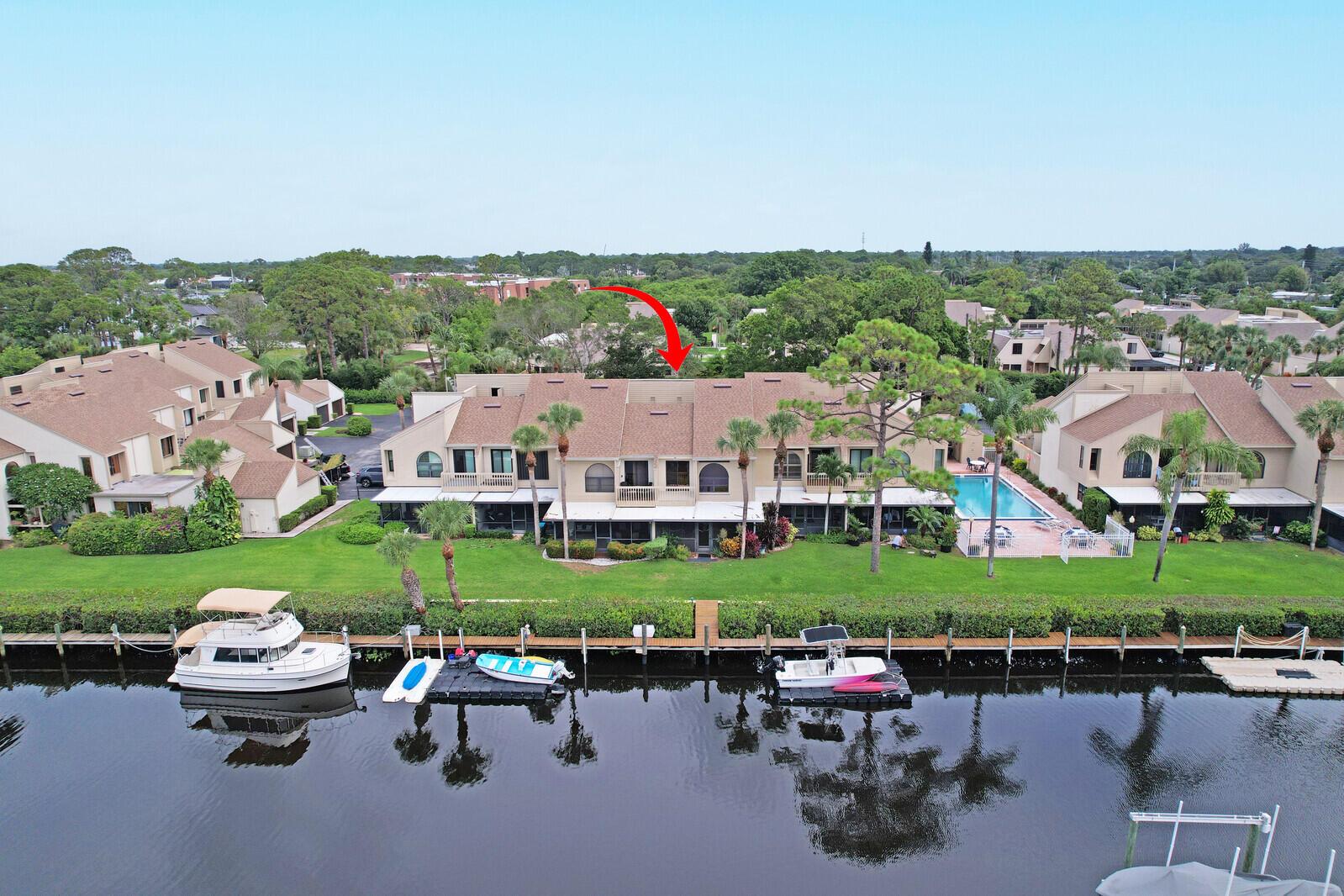 Enjoy wide water views and direct ocean access with no fixed bridges from this well-maintained 3-bed, 3-bath townhome in peaceful Tarpon Bay Moorings. A private 40-foot dock and community pool are just steps from your back door. Fresh interior paint makes this home move-in ready. Both AC units have been updated in the past three years, and the roof was replaced in 2021. The main level features a full bedroom and bath--ideal for guests or a home office. Upstairs, the primary suite offers a private balcony overlooking scenic Kitching Cove. A versatile loft adds space for an office, lounge, or storage. Conveniently located near beaches, shopping, medical facilities, and downtown Jensen Beach. A rare chance for relaxed waterfront living with direct boating access.