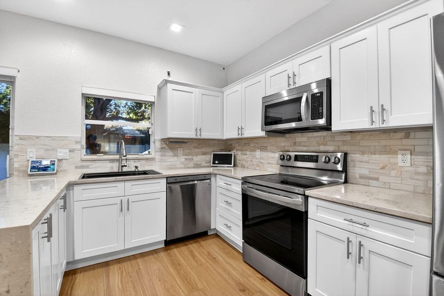 Welcome to modern luxury in the gated enclave of Pine Grove. This stunning 3BR/2.5BA home feels brand new, featuring high-grade laminate flooring and sleek recessed lighting throughout. The open floor plan boasts a living room, dining area, and family room centered around a gourmet kitchen with stainless appliances, a farmhouse sink, and two breakfast bars.

Upstairs, a versatile loft leads to two spacious guest rooms overlooking the yard and a fully updated second bath with a soaking tub and frameless shower. The massive primary suite includes a private sitting area and a spa-like ensuite featuring dual sinks, an oversized lighted mirror, a jacuzzi tub, and a custom pebble-stone shower. Relax on the covered patio or enjoy the security of a 1-car garage and hurricane panels.