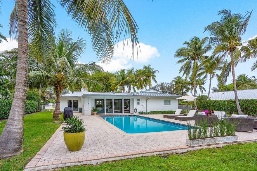 Experience the best of Florida in this beautifully remodeled ranch-style home, perfectly nestled on a large lot in the highly sought-after estate section of Lake Ida. Located on a quiet cul-de-sac street, this property offers both an upscale, private feel and comfortable living.  The split bedroom plan ensures privacy for family and guests alike. The private master suite boasts his-and-hers closets and direct access to the pool and backyard. Enjoy the Florida sun and warm weather in the large, heated pool surrounded by an expansive, wrap-around paved patio. The large, private fenced yard is perfect for your beloved pets. The home is quiet and protected with impact windows and doors. Two-car garage and circular driveway provide plenty of space for visitors. Beach pass & golf cart included.