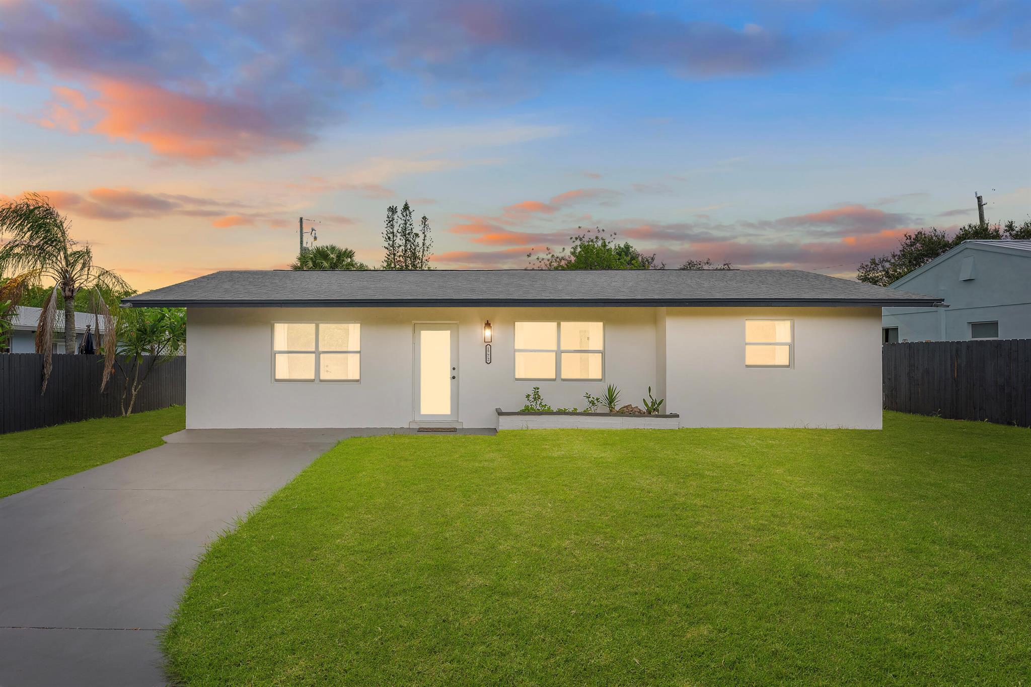 Modern, renovated 3-bedroom, 2-bathroom Jensen Beach home close to the surf with opportunity to rent half as an Accessory-Dwelling Unit (ADU) or Mother-In-Law Quarters! Updated kitchen with custom-wood-soft-close cabinets, ivory-quartz countertops and backsplash and new stainless appliances. Open-concept, 1,106-square-feet, with marble-porcelain-tile and impact-front door providing extra light. Sleek, black accessories include modern lighting, faucets and knobs. Large-main bedroom with private-entrance has en-suite bathroom - black-marble-tile shower with glass door, wooden vanity and lighted mirror. New stainless-stackable washer and dryer. That space has side-entrance door and private door to main house. Could be rented as studio to pay mortgage. Airbnb and mid-term .