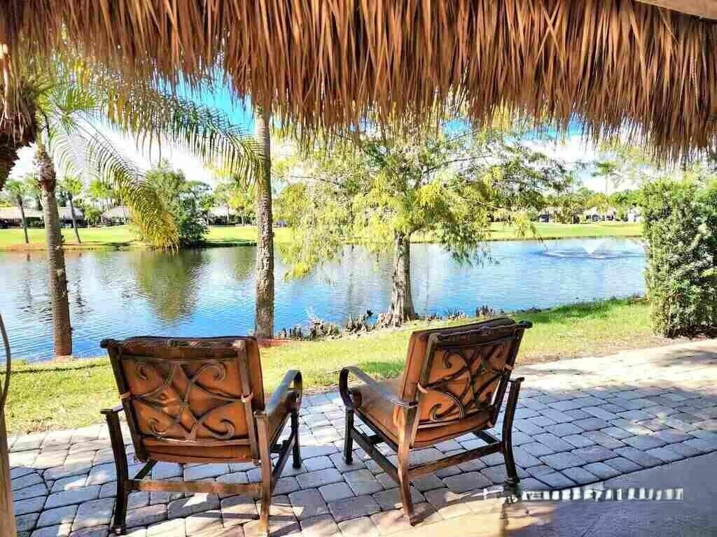Paradise defined at the Motorcoach Resort at St. Lucie West! If beautiful sunsets over a lake and the tranquility of water fountains are your idea of paradise - look no further! Great back-in lot located close to the main entrance and the clubhouse. Large tiki with well equipped kitchen including a dishwasher and full size refrigerator. Motorized eisenglass shades deploy at the push of a button to allow for outdoor enjoyment in case of inclement weather or chilly night. Nice landscaping and mature trees add privacy and shade. Easily accommodates a 45' coach! Also a designated spot for your golf cart. 18 hole golf course, pool, gym, pickleball, dog parks are only a few of the amenities that accent a full social calendar during season! Class A coaches only for this gated community.