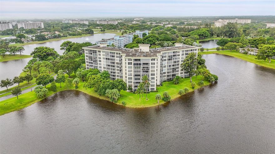 Corner unit filled with natural light, featuring extra windows in both bedrooms and bathrooms. Spacious 3/2 layout with porcelain tile throughout, granite countertops, shaker cabinetry, and stainless-steel appliances. Primary suite offers a walk-in closet with custom built-ins. Enjoy lake views through impact windows accented with plantation shutters. Conveniently located near I-95, shopping, grocery stores, and banking. Community provides laundry on every floor plus an additional storage area. Furniture available for purchase.