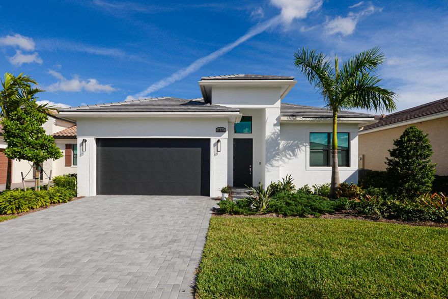 Beautiful ''Julia'' Model in Verano (PGA Village) just like New! Why build when you can get this home still under the 1st year builder warranty. Features CBS Construction, Flat tile Roof, paver driveway, Transitional Exterior, hurricane impact windows & doors.  Hosts 3 BR's, 2 BA's, 2 CG & spacious covered lanai with Lake View! Fabulous Open floor plan, tile in main areas, Great Room, Volume ceiling & natural lighting. Gorgeous kitchen includes White Cabinets, Stainless steel appliances with Wall Oven, cook top, hood, microwave, large Island with quartz counter tops & walk in Pantry. Custom electric window treatments.  All it needs is your personal touch. Nothing to change - come in and decorate the way you want. Verano feels like a Resort offering something for everyone! HOA includes:Recreation clubhouse Talavera, lawn care, exterior pest control, cable, high speed internet, alarm monitoring & manned gated security. PGA Verano is a resort style community with 27 pickle ball courts, tennis courts, fitness centers with state of the art equipment, indoor and outdoor pools, sauna, and dog park. Exceptional Talavera Social Club 19,000 sq ft. New additional Gym fit bit technology & resistants pool. There is a golf cart path to the PGA Golf Club which offers 3 Public Championship Golf Courses and Private Course (membership optional). Located minutes from Shopping, Restaurants, Activities, Entertainment & Even Home of the New York Mets Spring Training. Only 45 Minutes from Palm Beach Airport and a growing area. The Treasure Coast has beautiful Waterways for the Beach, Fishing & Boating. Due to the location of the Treasure Coast the Weather is delightful!