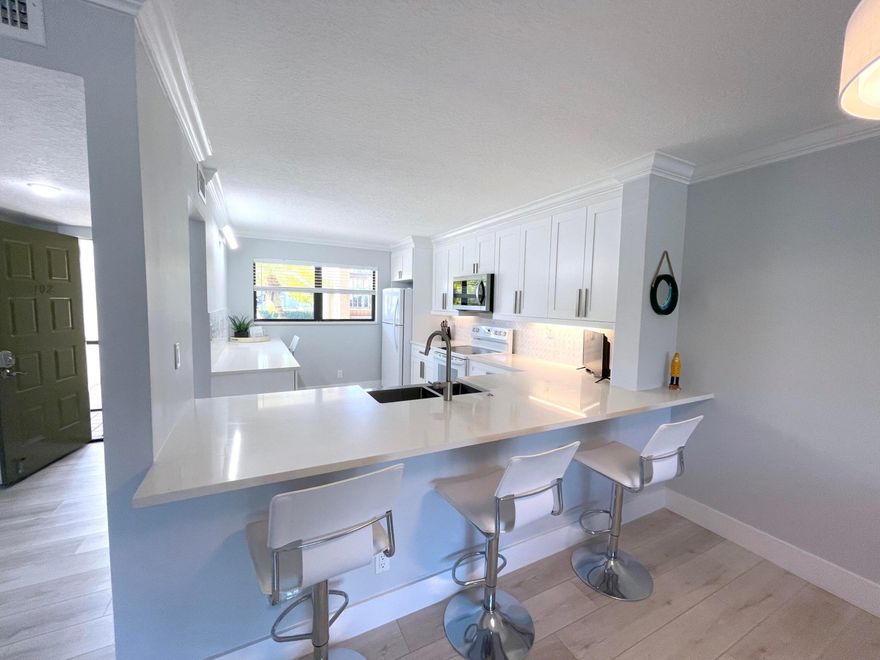 Furnished 2BR/2BA First-Floor Condo | Eastpointe CC | Palm Beach Gardens  Renovated 2-bedroom, 2-bath first-floor condo offered furnished in Eastpointe Country Club. Interior features include a spacious open floor plan, updated kitchen with quartz countertops and bar seating, and combined living and dining areas.  Property includes a screened patio with custom full glass enclosure, providing extended, temperature-controlled living space. Ground-floor location offers convenient access and functional layout.  Located in a gated community with 24-hour manned security and access to golf, tennis, pickleball, fitness centers, clubhouse, and pools. Convenient Palm Beach Gardens location near shopping, dining, and major roadways.