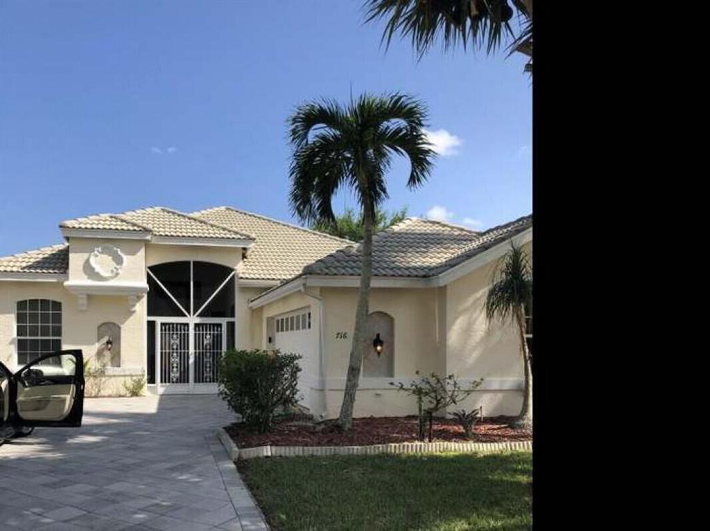 Photo of 716 SW Lake Charles Circle, Port Saint Lucie, FL 34986 (MLS # R10722115)