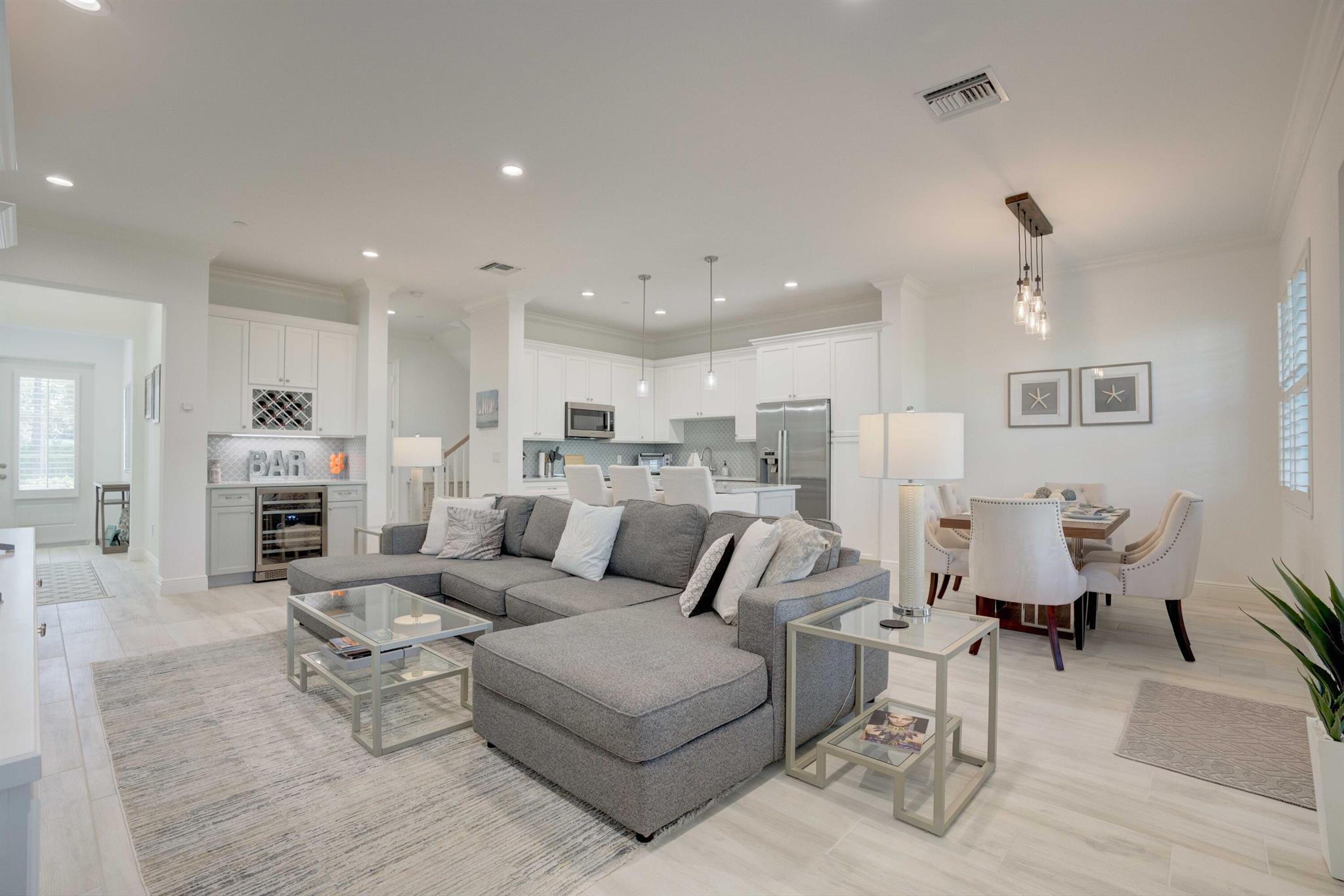 Key West Style 3Bed/2.5 bath/2 car garage townhome that combines traditional elegance with an open and spacious design. This tastefully furnished home with soaring ceilings offers an open floor plan seamlessly connecting the living room, dining room and kitchen through to your relaxing outdoor covered porch. The second floor offers a split floor plan with 3 spacious bedrooms, open office/loft area, 2 full bathrooms and laundry room. The exquisite primary suite offers 2 walk-in closets and a private balcony overlooking the pool. The community offers a pool, hot tub, cabana, and a waterfront walkway with a day dock. Enjoy the carefree lifestyle just minutes to the beach. Inlet Waters is near all the local restaurants, beach, shops, Jupiter Lighthouse and Dubois Park.