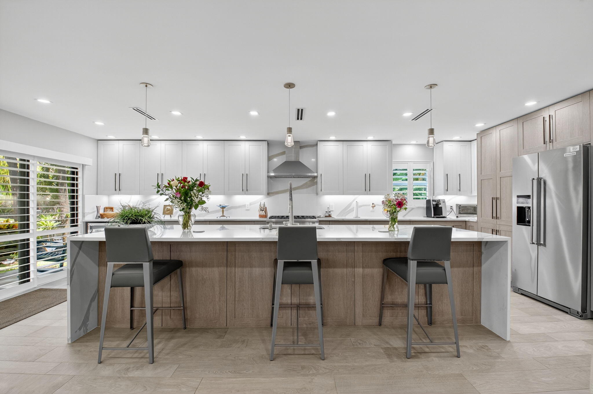 This stunning, fully renovated condo offers luxurious coastal living with designer finishes and a sleek, modern aesthetic. Located directly across the street from the beach, this residence features canal views from the kitchen, dining, and living areas. Enjoy ocean access via a deep water canal with a common dock--bring your boat (up to 30 ft)! Note, there is a waiting list for boat slip. The chef's kitchen boasts Thermador appliances and rare natural gas cooking, plus a gas dryer and water heater for added efficiency. The open layout, spa-inspired baths, and premium upgrades throughout make this showplace truly move-in ready.