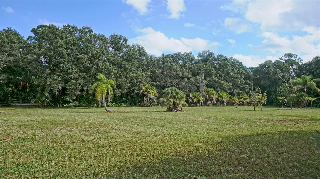 Unlimited possibilities abound on this beautiful, high and dry 4.62-acre parcel on a paved road in Palm City Farms. The property is fenced, mostly cleared, and has a variety of mature Oaks and Palms offering plenty of shade. There is a pretty stocked pond and shed on the property. Come build your dream home and enjoy peaceful country living yet close to all major highways, shopping, dining, and beaches. This property is located in a desirable Martin County school zone.