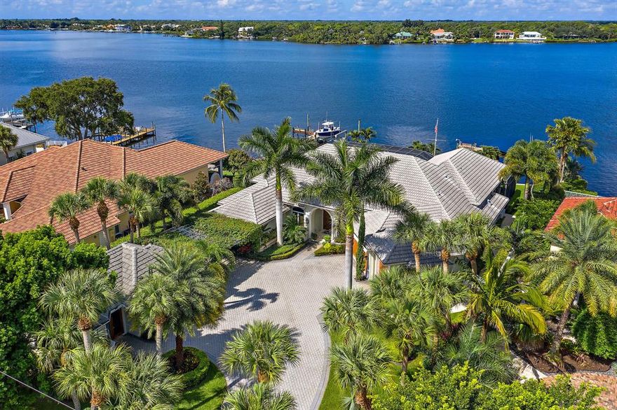 This incredible waterfront home has it all. 100 ft of direct Loxahatchee river, totally updated home with massive kitchen/bar area. 2 master suites, marble and wood floors. All impact doors and windows, whole house generator, a separate guest house with a full kitchen to make your guests feel like they have their own home.Large dock with room for all the toys, a covered area for your boat. This home is not the oversized waterfront home that so many are. perfect size and all on one floor.