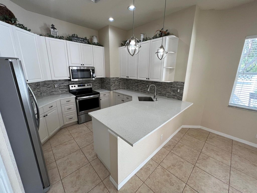Photo of 5542 Boynton Gardens Drive, Boynton Beach, FL 33437 (MLS # R11112954)