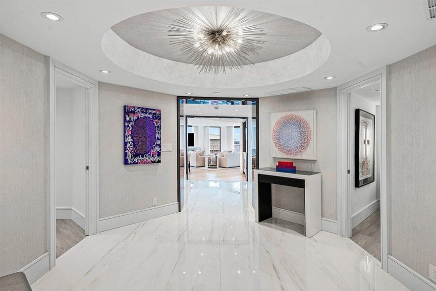 Total renovation, just completed! Luxurious, turnkey 3 bedroom/3 full bathroom SW-facing high floor condo with stunning intracoastal and ocean views awaits you. Step inside this elegant unit and you'll be greeted by a bright foyer followed by a spacious dining room/living room combination featuring electric shades, custom sheers, and LED lighting throughout, perfect for entertaining or simply relaxing in style. Brand new hurricane impact sliding glass doors open to the balcony, where you can enjoy the serene water views. The open kitchen is a chef's dream, equipped with high-end induction cooktop, wine fridge, double oven with convection, microwave, steam, air fryer and toaster, WiFi enabled appliances, Caesarstone countertops, and ample cabinet space, including an 11-foot island.