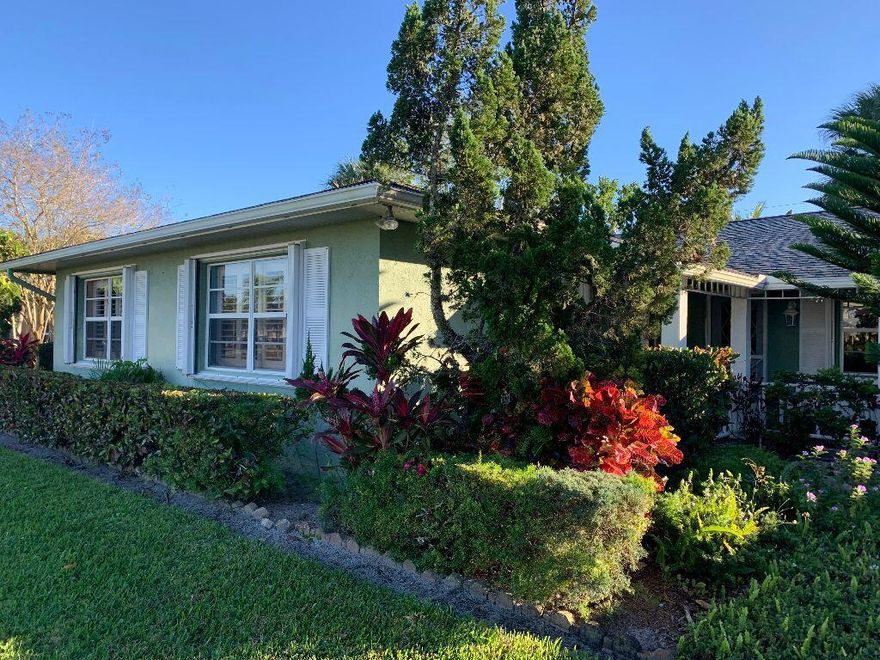 This adorable home has 2 bedrooms with attached bathrooms. large living room with wood burning fireplace, screened back patio, fenced in back yard with mature landscaping, and open kitchen with pantry and pass through to the back patio. In need of updating but has accordian hurricane shutters  and plantation shutters on most windows inside.   Laminate and tile floors throughout. Roof is 1999.  Auto sprinklers on well