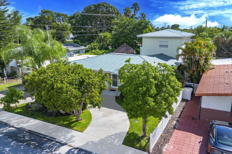 This 4-bedroom, 3-bath pool home is made for Florida living!  NEW LVT flooring. The open layout highlights the pool and backyard oasis with outdoor kitchen, and new tiki hut. Perfect for entertaining! Inside features tile floors, granite counters, stainless appliances, and a 110-gallon faux fish tank. Upstairs, the master suite offers a walk-in closet, balcony overlooking the pool, steam shower, and jetted tub. Metal roof, impact sliders, and shutters complete the package -- all minutes from the Intracoastal, beaches, and downtown Lake Worth Beach. The furniture is negotiable.