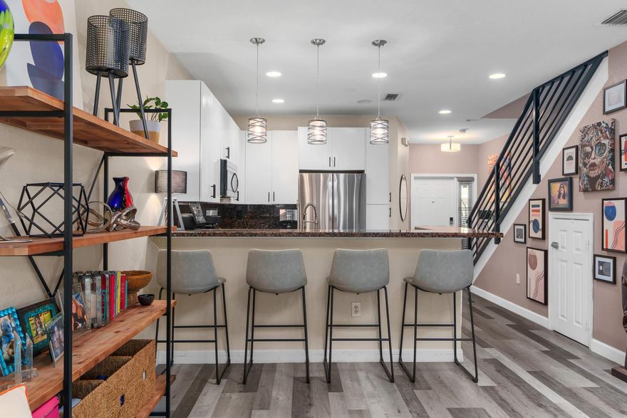SELLER MOTIVATED READY TO MOVE IN! This Beautiful Two Bed Two 1/2 Bath Home won't last long! Gated Community. The herringbone brick driveway and barrel-tiled roof welcome you home as you enter the generously spaced kitchen and living area. LVT Plank  throughout the home highlights the upgrades and features including newer LG SS appliances and the newer AC will keep you cool as you proceed to the outdoor patio with lush garden. It's the perfect layout for parties and entertaining. The custom staircase leads you upstairs to plenty of storage and convenient laundry. Two generous bedrooms and two remodeled marble bathrooms with rainfall shower heads and step-in shower in the primary will be your light-filled sanctuary. Sparkling pool close by. Ask about interest rate buy-down.