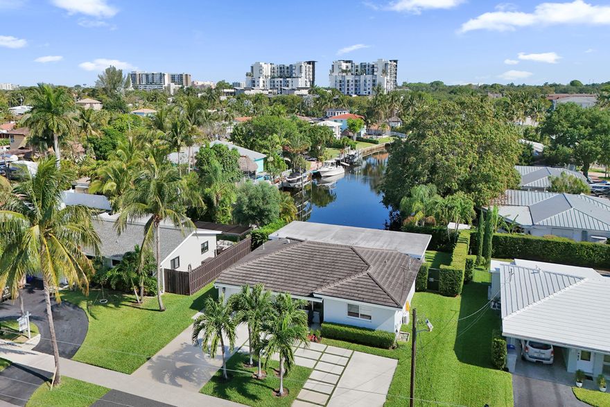 Perfectly positioned to capture rare, stunning waterway views looking straight down the canal w/ ocean access. Completely renovated & redesigned in 2019, this stylish home features a stunning open kitchen with rich quartz countertops, modern tiled backsplash, gas range with professional hood, creating a seamless flow into expansive living areas. Grand 25X14 family room addition enhances the open-concept layout ideal for entertaining. Wide plank LVP flooring throughout, complemented by impact glass, beautifully updated modern bathrooms, w/ high-end designer finishes. Major upgrades include full cast iron plumbing replaced to PVC & whole-house generator fueled by natural gas. Smart home features, tiled patio & covered Lanai overlooking one of the most spectacular waterway views in the area.