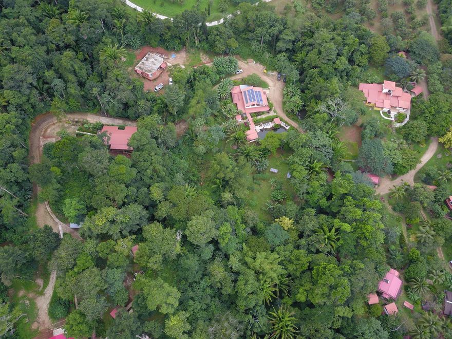 Rare opportunity to acquire a fully established eco-retreat center and off-grid micro-village in Belize. Sattva Land spans approx 20 acres of lush tropical rainforest in the Stann Creek District, with convenient access from the scenic Hummingbird Highway. The property features multiple eco-designed accommodations, a restaurant and cafe with commercial kitchen, a yoga and wellness center, permaculture gardens, jungle trails, and a natural spring-fed swimming pool. Designed for wellness retreats, transformational workshops, eco-tourism, and intentional living, the estate operates fully off-grid with solar power and on-site freshwater systems. Centrally located between Belmopan and Dangriga, and within reach of beaches, waterfalls, and protected natural reserves. Buyer to verify all info.