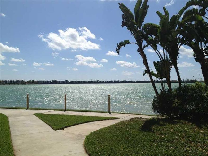 Lake Emerald truly is a magical place! Direct lakefront 2/2 unit sits at the edge of a 168 acre lake with awesome lake & sunset views forever.  Corner unit has expanded water views. Italian porcelain floors t/o, split br plan, w/d. Owner installing new A/C!  24 hr. guarded community has 3 heated pools & spas, tennis cts, fitness center & much more. Premium cable tv incl in condo fee. Low down OK due to significant reserves in the HOA. Sm pet OK. Why not live the way most people pay to vacation?!?