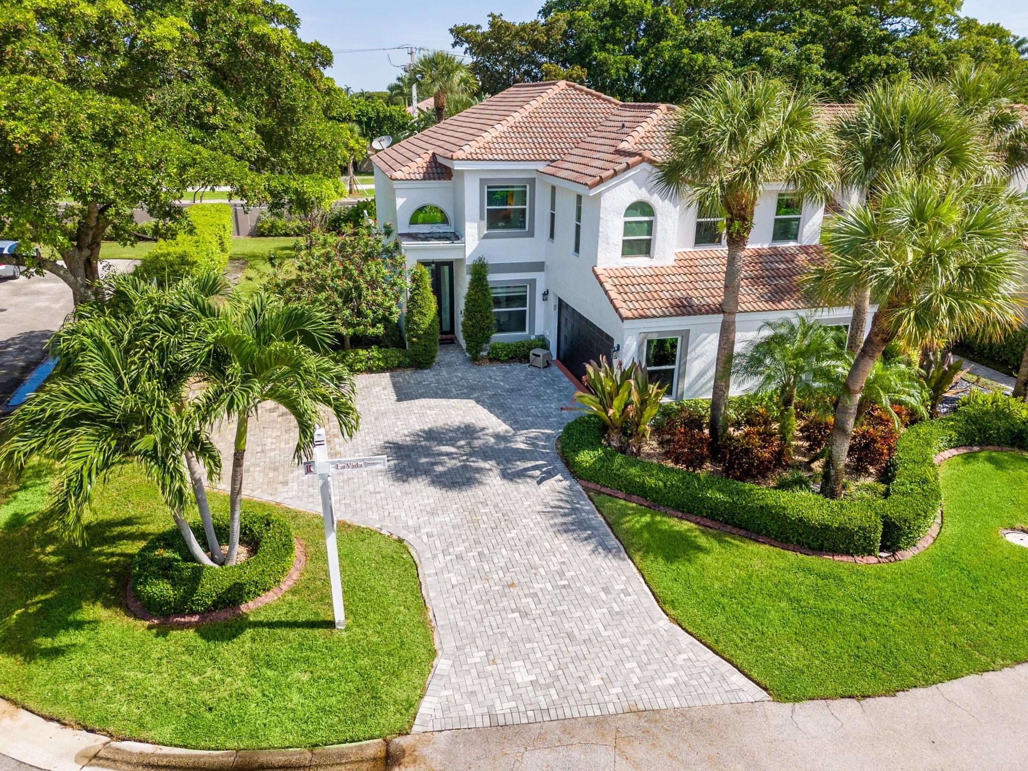This updated residence blends modern design, comfort, and convenience on the most desirable corner lot in La Vida Boca Raton.
Inside, brand-new vinyl flooring flows seamlessly throughout, complementing a modern island kitchen with sleek cabinetry, stainless steel appliances, and ample counter space—perfect for everyday living and entertaining.
Soaring 18-ft vaulted ceilings add light and volume. Enjoy Florida living with a modern pool and travertine deck, ideal for relaxing weekends or hosting guests. Impact-rated windows and doors provide peace of mind and efficiency
Located within an A-rated school district, this property is perfect for families seeking both style and substance.
Don’t miss this move-in-ready home in the heart of Boca Raton, minutes from dining, shopping, and beaches.