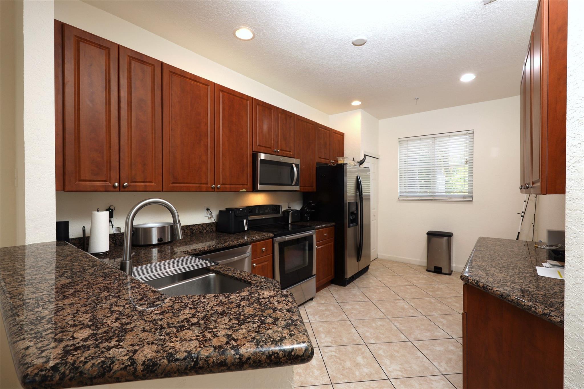 Just up the street from Atlantic Ave In Delray with all the great nightlife. This private end-unit townhome is ideally located, just 1 mile from the beach. Easy access to outdoor waterfront dining and the lively scene of Downtown Delray Beach. Fishing at Boynton Pier nearby. Townhome boasts a spacious eat-in kitchen with granite counters and SS appliances. Neutral tile flooring throughout the living room and kitchen. Hurricane impact glass, bedrooms upstairs, private washer/dryer, and 2 assigned parking. The master suite includes 2 large closets and a modern ensuite bath with a bubble bath tub and shower. Community pool. Seller offering $1500 carpet credit at list price. New roof, Painting, Concrete work on all the steps. EZ SHOW & GO