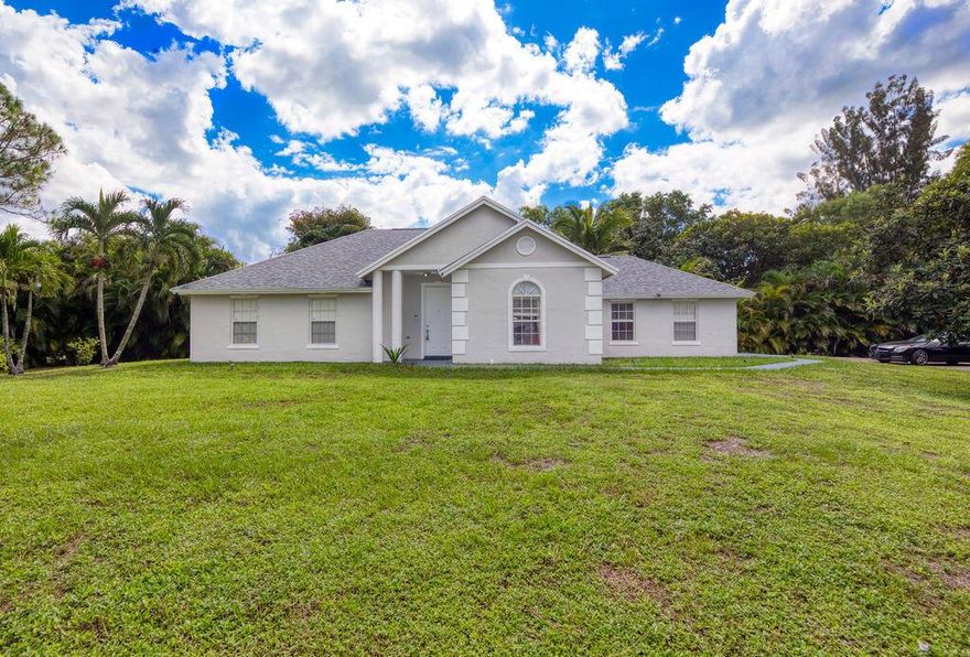 Welcome to this beautiful acreage retreat set on 1.19 fully fenced acres with an electric gate providing privacy and security. This property features a brand-new roof and water heater, and plenty of space to park your cars, boat, RV, or even horses. The freshly painted interior showcases tile flooring throughout and an upgraded kitchen with granite countertops and premium Samsung appliances that open to the great room, perfect for entertaining. The spacious master suite offers a custom closet and a beautifully renovated bathroom. Enjoy a large family room ideal for movie nights or storage. Step out to your screened lanai overlooking the sparkling pool and take in the stunning sunsets across your peaceful acreage.