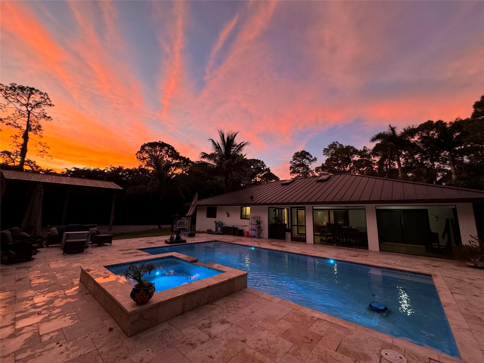 Experience Florida living at its finest in this fully renovated home on a quiet paved road. The private backyard oasis features a new pool & hot tub, spacious tiki hut, and a pole barn with enclosed storage—ideal for entertaining, relaxing, or storing your toys. Enjoy peace of mind year-round with a whole-home generator, impact windows & doors, and a metal roof. Inside offers modern finishes, new appliances, and a whole-home RO water system. A large concrete driveway and irrigated landscaping complete this rare Jupiter Farms rental!