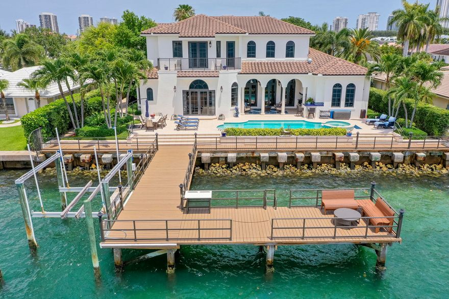A truly stunning waterfront property with the best views on all of Singer Island. This 4BR 4/2BA + loft home is the ultimate boater's paradise, complete with a private dock and 12,000 lb boat lift. The level of detail and sophistication can be seen throughout, from the grand entrance with coffered volume ceilings, crown moldings, and built-in surround sound to the custom kitchen with seamless gas appliances and beautiful wood cabinetry. Enjoy breathtaking sunsets and skyline views from the back patio featuring a full summer kitchen, heated pool and spillover spa, all surrounded by the crystal blue waters of the intracoastal. From the elegant finishes to the unparalleled water views, this spectacular home is the perfect South Florida retreat.