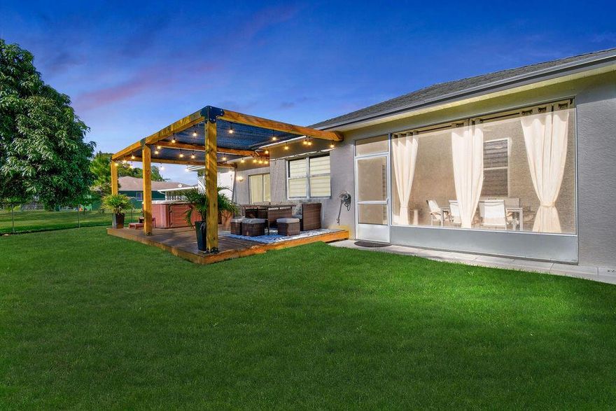Beautifully renovated 3/2 CBS home with a brand new wooden deck, deluxe hot tub & pergola to enjoy beautiful sunsets & endless entertaining!! The kitchen has been tastefully updated with quartz countertops, backsplash & newer SS appliances that perfectly accentuate the modern grayish blue cabinets.  The entire home features new waterproof laminate flooring & new lighting throughout.  Both bathrooms have been completely renovated with new tile, lighting & faucets.  The interior & exterior were recently painted and all new landscaping was placed in the front & back yard & a brand new shed was recently installed.  The screened in porch was tiled and the wood deck, jacuzzi & pergola are brand new!!  If you love mango you will love this home. There are 2 mango trees that bear a ton of fruit. This home is MOVE IN READY!!  Located in the heart of Port St. Lucie and centrally located to the Turnpike, 95, St. Lucie West Tradition shopping dining, hospitals & the beaches.