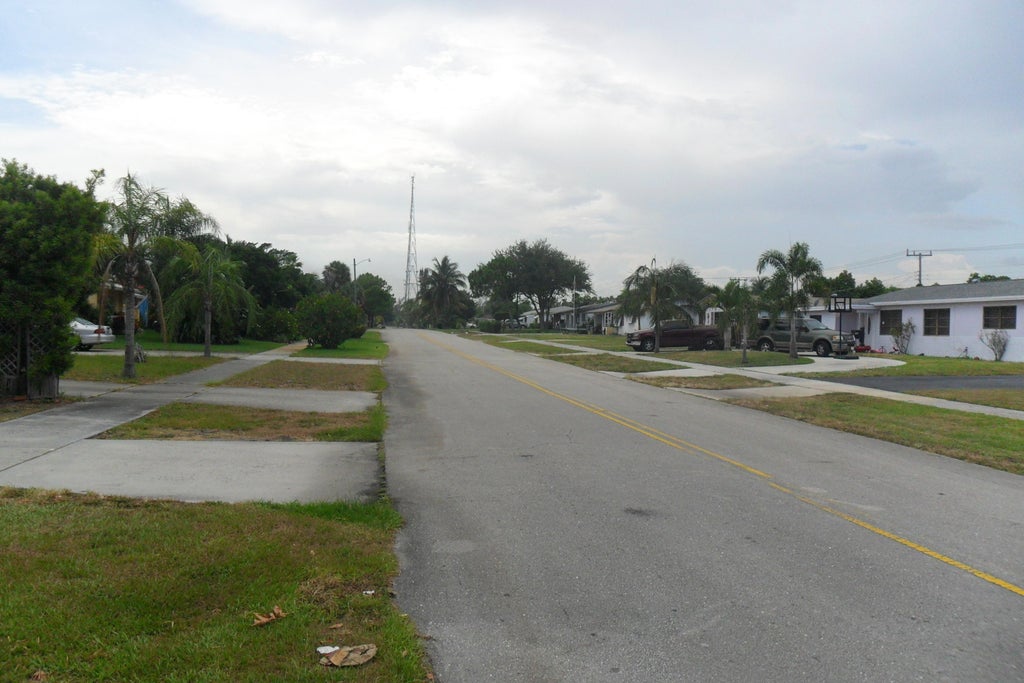 Photo of 730 W ILEX Drive, Lake Park, FL 33403 (MLS # B26080946)