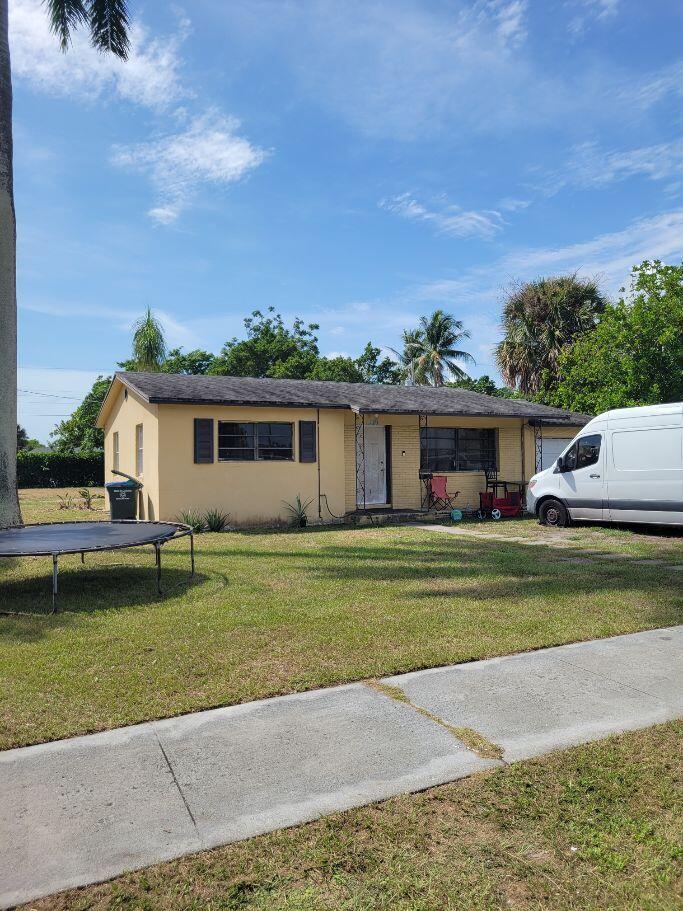 Photo of 730 W ILEX Drive, Lake Park, FL 33403 (MLS # B26080946)