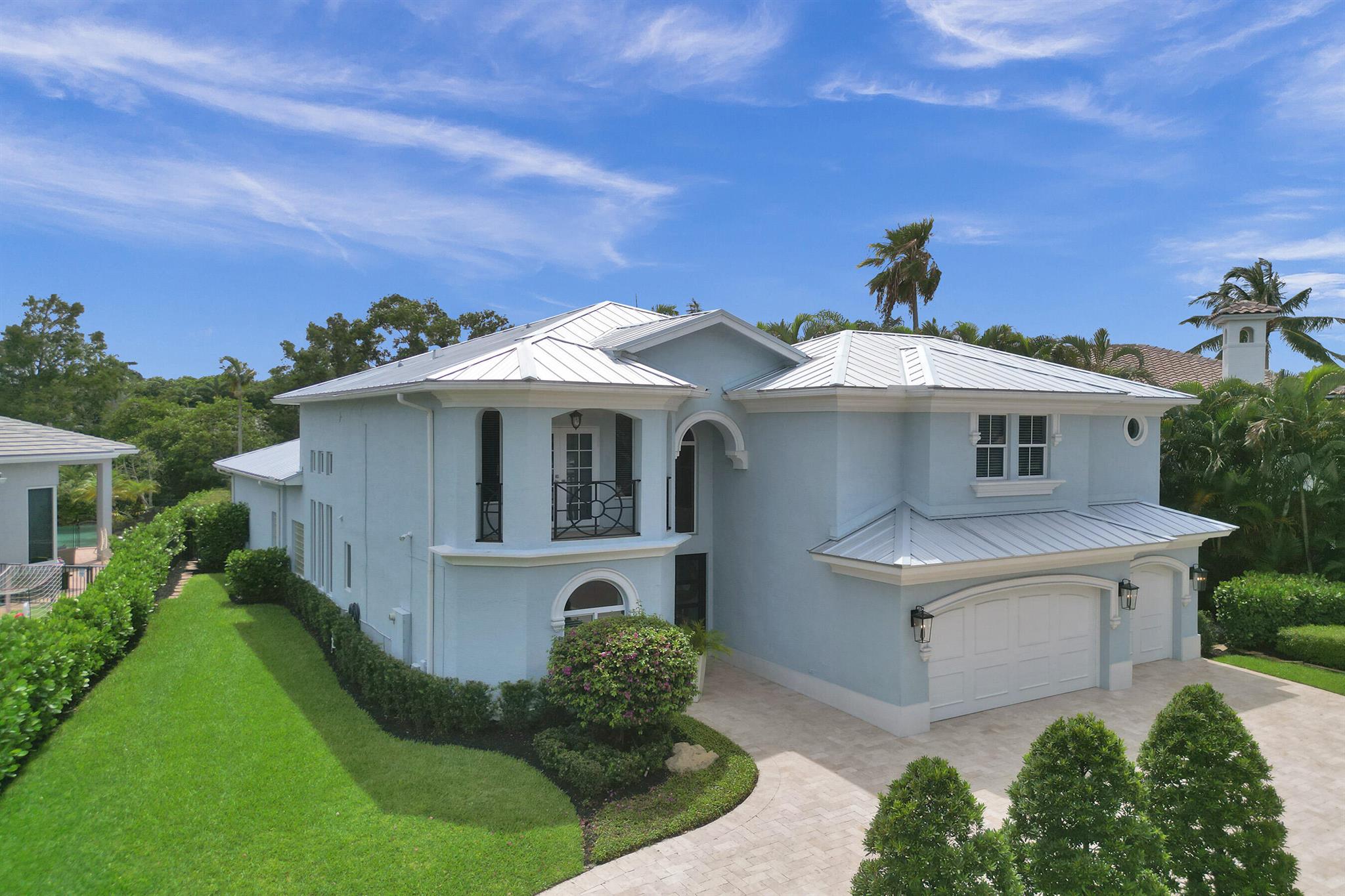 This 5/4 Lake Front gem is situated on a sunny southern exposure lot. Expertly landscaped front & back with a 3 car garage and travertine marble paver driveway & walkway. Inside features wood flooring & soaring ceilings adding to a feeling of openness with an abundance of natural light. The kitchen is recently updated, open to the family room & sure to please even the most discerning Epicurean. Lower level primary suite is spacious w/lake views. Outstanding features incl updated baths, new metal roof, full impact glass & natural gas generator. A MUST SEE!