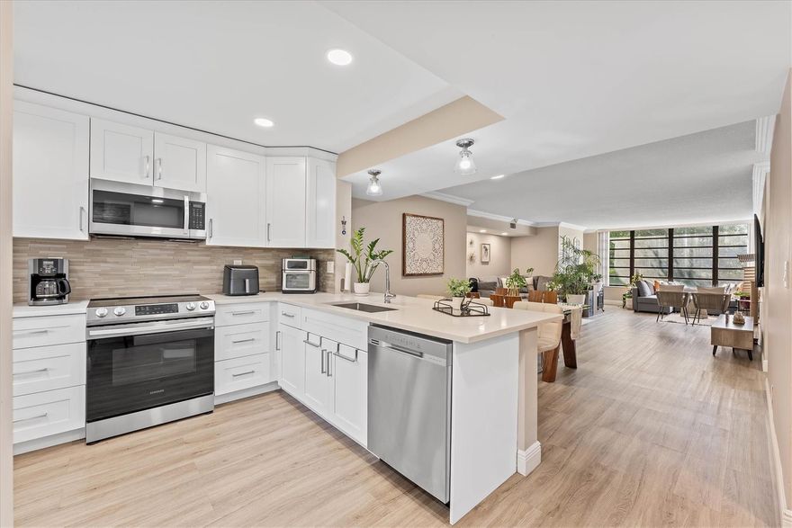 Imagine coming home with the most breathtaking views of water and preserve, quiet, and exactly where you want to be. Step inside your corner unit in your tastefully remodeled property. Sunlight pours across a bright, open layout in an upgraded kitchen with New SS appliances and quartz countertops. A stylish bar area in the entryway includes two wine coolers and additional storage. Fully upgraded bathrooms and floors with baseboard and crown molding throughout. The primary suite offers a walk-in closet and en-suite bath with walk in shower. New A/C and Water Heater. Great Township amenities offer pools, jacuzzi, sauna, fitness center, movie theater, tennis courts and much more. Great location just minutes away from the Promenade Mall, Turnpike. 40 Years Certificate, New Roof. NO Special ASS