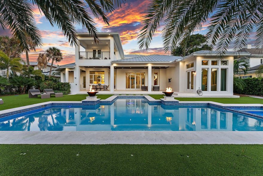 SPECTACULAR 2021 Waterfront home in Hidden Key, one of the Northern Palm Beaches most exquisite enclaves.  This Modern 5 BR estate home offers a serene coastal aesthetic w/ impeccable finishes throughout. Every detail has been finely curated to create the perfect Florida lifestyle, blending indoor + outdoor living.  A grand circular drive and double door entry welcome you to an oversized living area with beamed ceilings and full wall sliders that open to a grand loggia.  The adjacent chef's kitchen with Miele appliances, a breakfast area + huge island adds perfect space for intimate or grand entertaining.  A massive Owners suite offers privacy + serenity, graced by a windowed seating area, dual custom closets and a spa  bath.  There is a spacious second bedroom on the lower floor as well