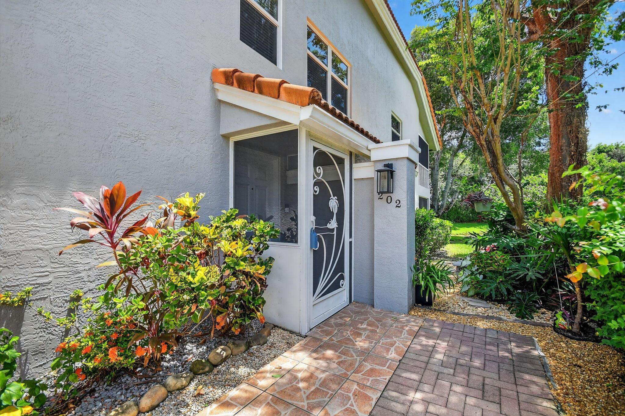 Come experience Florida living at its finest in this beautiful end unit with open floor plan and perfect, serene location with lake views. Home has new AC with new impact windows and sliders throughout. Spacious 3 bedroom, 2 bathroom with third bedroom being used as an office. The private, glassed in and screened, lania provides ample space for outdoor entertaining and relaxation while overlooking the lake. Eat in kitchen has all new stainless steel appliances and a reverse osmosis drinking water filtration system. Full washer and dryer in unit. . Guest bathtub replaced with beautifully tiled walk in shower with niche. Newly renovated club house will be opened soon and hosts loads of amenities. Open 7 days on-site cafe. Special assessments for completion of clubhouse all paid.